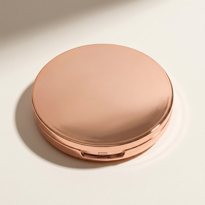 Illustrative fully closed rose-gold-tone blush compact neatly displayed.